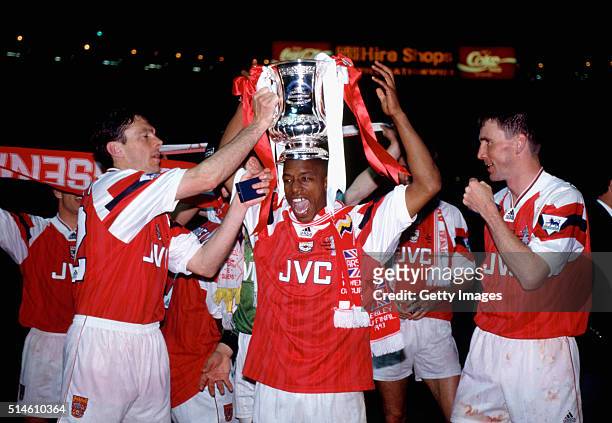 Arsenal goalscorers Ian Wright and Andy Linighan along with David O' Leary celebrate with the trophy after the 1993 FA Cup Final replay between...