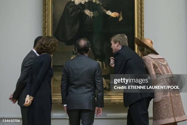 French President Francois Hollande , Netherlands' King Willem-Alexander and Queen Maxima look at full-length wedding portraits of Amsterdam couple...