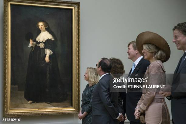 French President Francois Hollande , Netherlands' King Willem-Alexander and Queen Maxima look at the portrait of Oopjen Coppit, one of two...