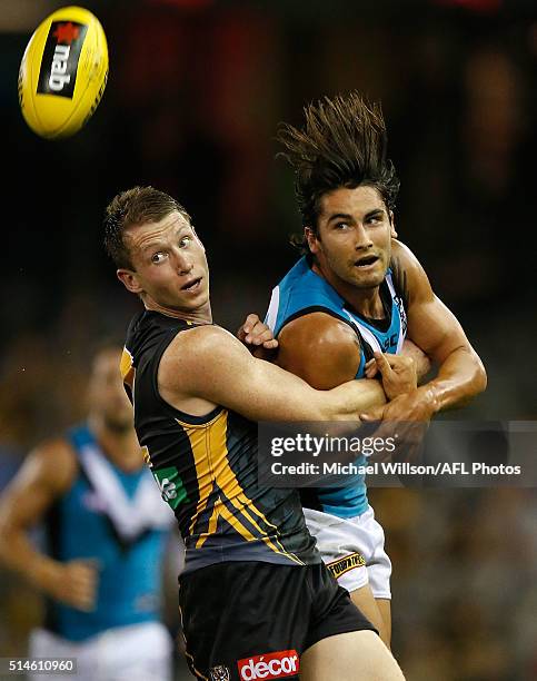 Dylan Grimes of the Tigers and Chad Wingard of the Power compete for the ball during the 2016 NAB Challenge match between the Richmond Tigers and...