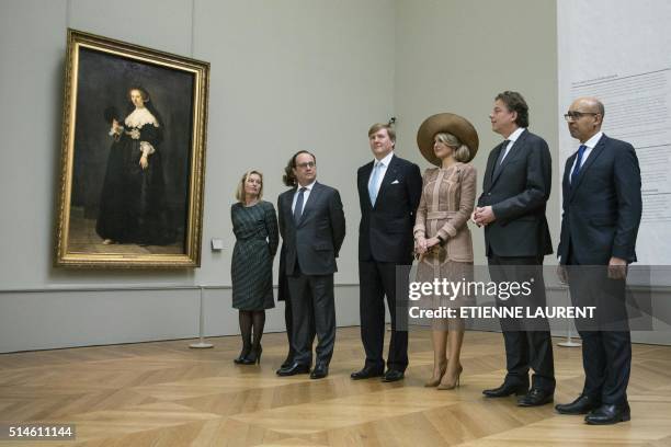 French President Francois Hollande , Netherlands' King Willem-Alexander and Queen Maxima listen to President-Director of the Louvre Jean-Luc...