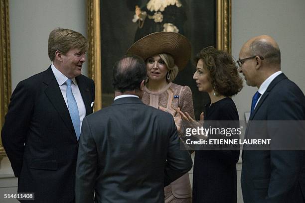 French President Francois Hollande speaks with Netherlands' King Willem-Alexander and Queen Maxima during their visit at the Louvre Museum on March,...