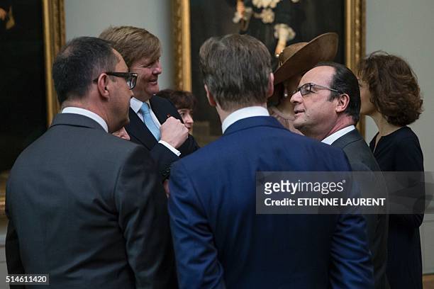 French President Francois Hollande speaks with Netherlands' King Willem-Alexander during their visit at the Louvre Museum on March, 10 March 2016 in...