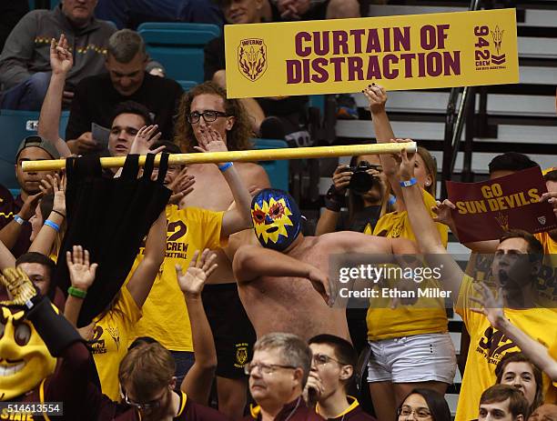 Arizona State Sun Devils fans try to distract an Oregon State Beavers player shooting a free throw during a first-round game of the Pac-12 Basketball...