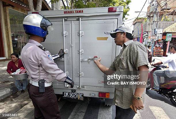 Policeman checks a van for explosives one day before the second anniversary of the Bali bombing in Kuta, Bali, 11 October 2004. Indonesia on Tuesday...