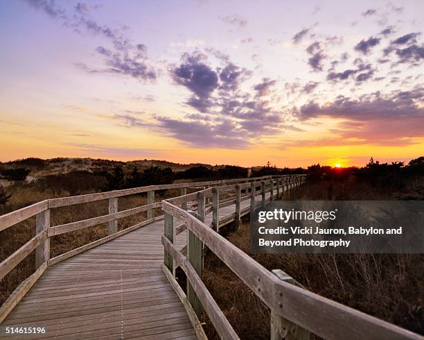 boardwalk to sunset at fire island - fato foto e immagini stock