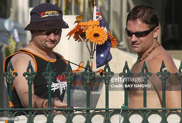 Australian tourists, Glenn Woollard and Damien Mahnoney , mourn for their friend in Kuta, Bali 11 October 2004. Indonesia on Tuesday marks two years...