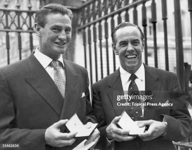 Australian test cricketers Keith Ross Miller , left, and Ian Johnson outside Buckingham Palace with their MBE's, 24th July 1956.