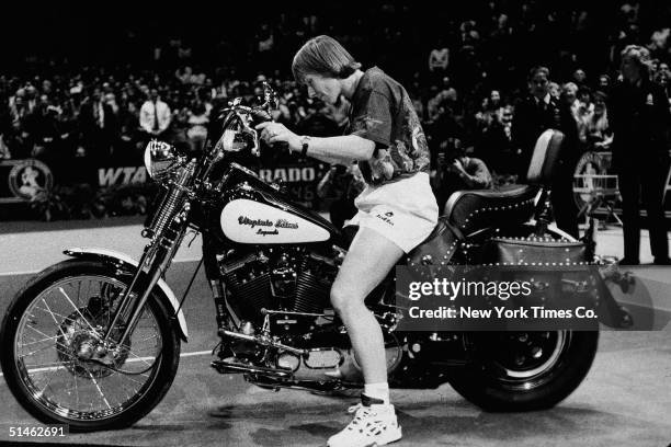 Czech-born American tennis player Martina Navratilova sits on a Harley-Davidson motorcycle at the Virginia Slims tournament in New York, November 15,...