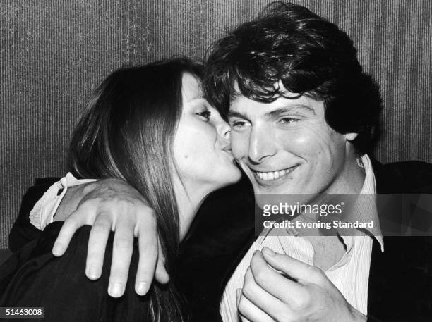 American actor Christoper Reeve , best known for his role as Superman, is kissed by his long term girlfriend Gae Exton, 19th February 1980.