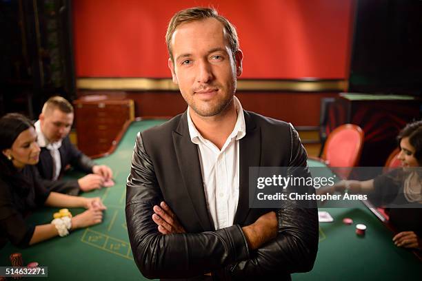 confident man in casino - casino dealer stock pictures, royalty-free photos & images