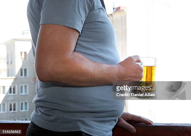 unhealthy drinking - bierbauch stock-fotos und bilder
