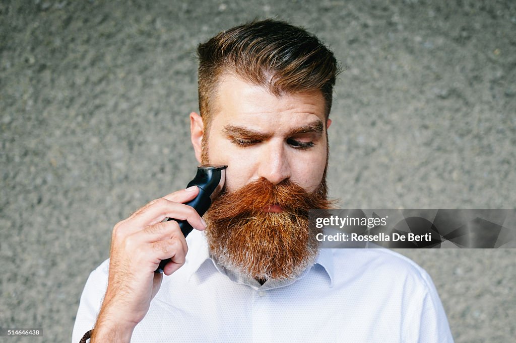 Portrait Of Bearded Man Trimming His Beard