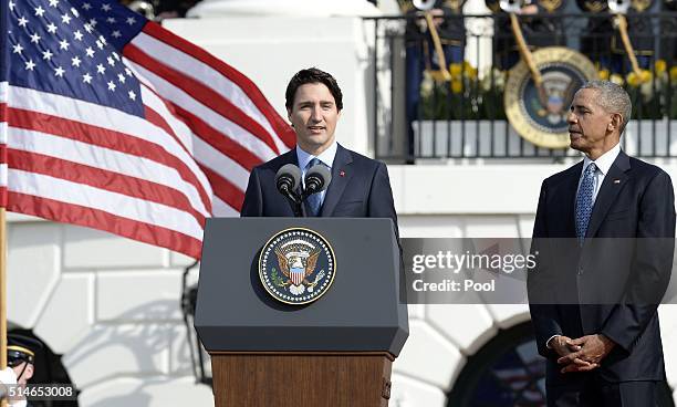 Canadian Prime Minister Justin Trudeau speaks as President Barack Obama looks on during a welcoming ceremony to the White House for an Official Visit...