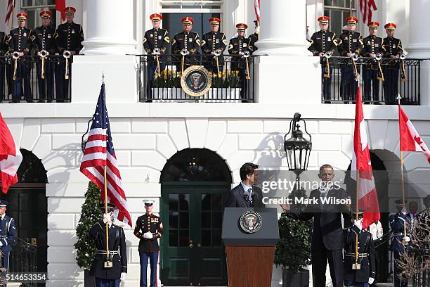 President Barack Obama reacts about the location of the Stanley Cup as he welcomes Canadian Prime Minister Justin Trudeau during an arrival ceremony...