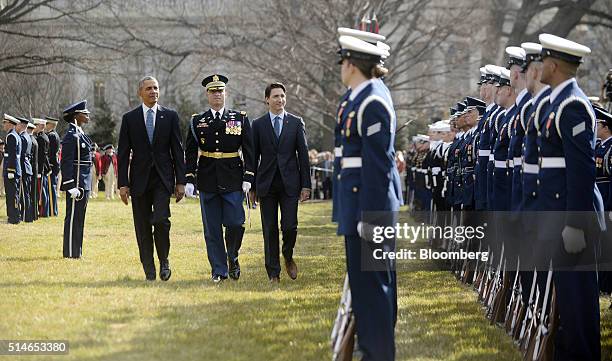 President Barack Obama, left, walks with Justin Trudeau, Canada's prime minister, center right, on the South Lawn of the White House during a...