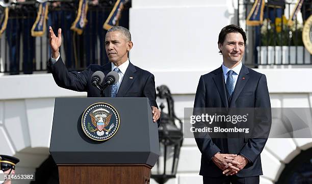 President Barack Obama, left, gestures during while speaking as Justin Trudeau, Canada's prime minister, looks on during a welcoming ceremony on the...