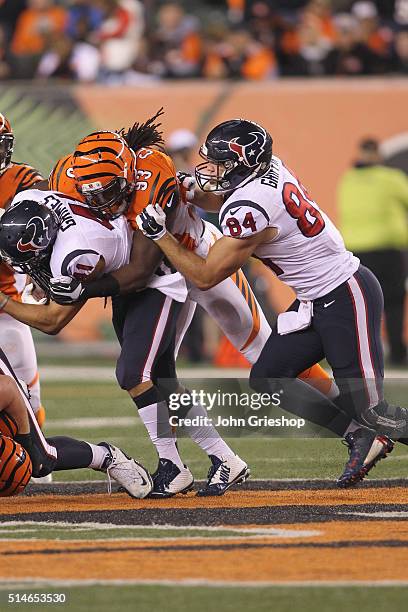 Jonathan Grimes of the Houston Texans runs the football upfield against Will Clarke of the Cincinnati Bengals during their game at Paul Brown Stadium...