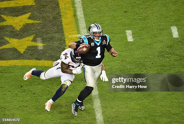 Quarterback Cam Newton of the Carolina Panthers carries the ball against DeMarcus Ware of the Denver Broncos during Super Bowl 50 at Levi's Stadium...