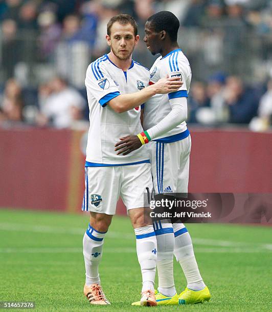 Ambroise Oyongo and Harrison Shipp of the Montreal Impact embrace during their MLS game against the Vancouver Whitecaps March 6, 2016 at BC Place in...