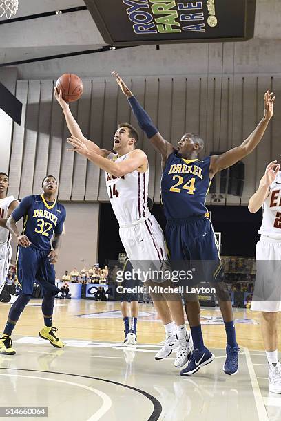 Jack Anton of the Elon Phoenix takes a shot over Rodney Williams of the Drexel Dragons during the 1st round of the Colonial Athletic Conference...