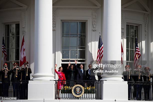 President Barack Obama, Canadian Prime Minister Justin Trudeau, First Lady Michele Obama, and Ms. Sophie Gregoire Trudeau wave to the crowds from the...