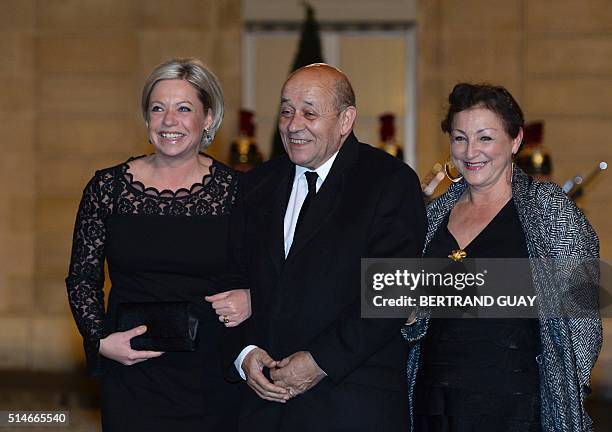 French Defence Minister Jean-Yves Le Drian , his wife Maria Vadillo and Dutch Defence Minister Jeanine Hennis-Plasschaert arrive for a state dinner...