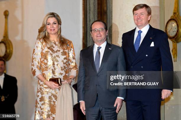 King Willem and Queen Maxima of The Netherlands pose with French President Francois Hollande upon their arrival for a state dinner in their honor of...