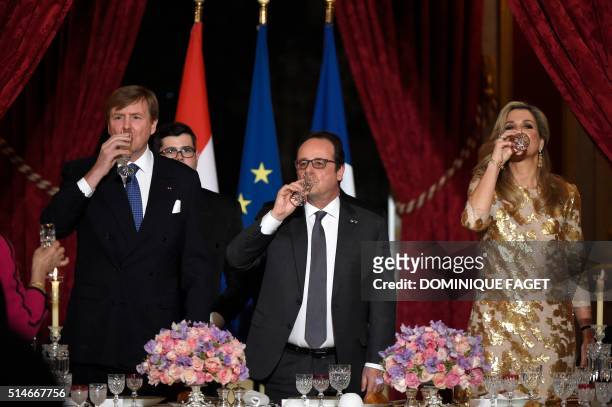 King Willem and Queen Maxima of The Netherlands, and French President Francois Hollande drink champagne during a state dinner in honor of the Dutch...