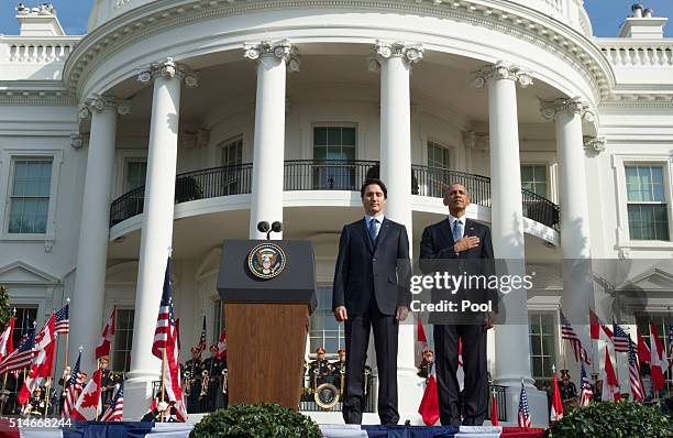 President Barack Obama and Canadian Prime Justin Trudeau stand for their national anthems during an arrival ceremony on the South Lawn of the White...