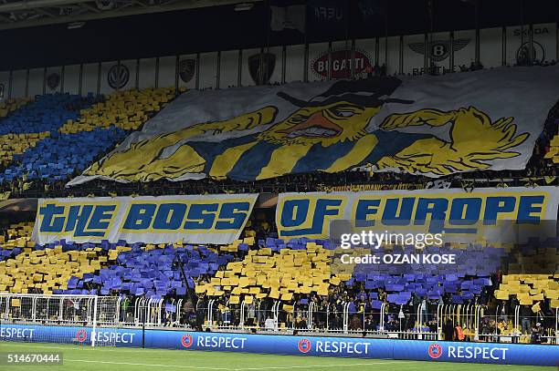 Fenerbahce's supporters cheer their team during the UEFA Europa League round of 16 football match between Fenerbahce and Braga on March 10, 2016 at...