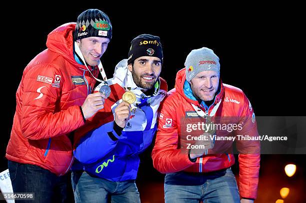 Martin Fourcade of France, Dominik Landertinger of Austria and Simon Eder of Austria pose with their medals after the IBU Biathlon World...