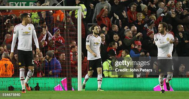 Chris Smalling, Daley Blind and Juan Mata of Manchester United react to Daniel Sturridge of Liverpool scoring their first goal during the UEFA Europa...