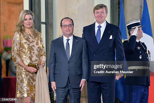 Queen Maxima of The Netherlands, French President Francois Hollande and King Willem-Alexander of The Netherlands pose in front of the Elysee Palace...