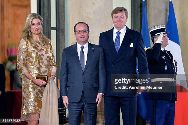 Queen Maxima of The Netherlands, French President Francois Hollande and King Willem-Alexander of The Netherlands pose in front of the Elysee Palace...