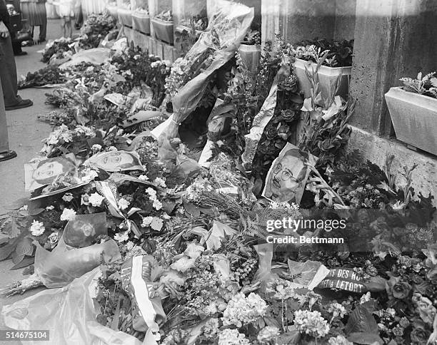 Paris, France: Flowers for Rosenbergs in Paris. Portraits of Ethel and Julius Rosenberg lie among the bouquets and wreaths of flowers laid by people...