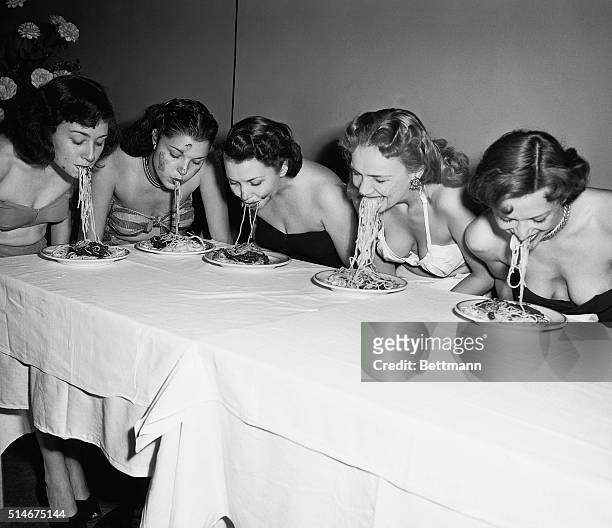Five Broadway show girls participated in a "Spaghetti Swooshing" contest. They had to eat a plate of spaghetti and sauce without using their hands.