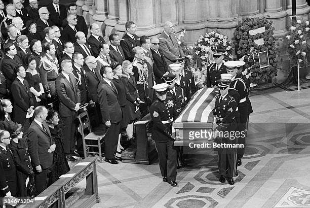 Pallbearers carry the casket of President Dwight Eisenhower at his funeral. In attendance are Mamie and John Eisenhower, President Nixon and his...