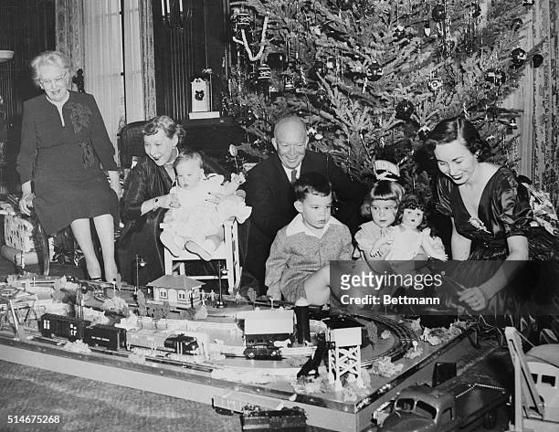 New York, NY: Gathered around the toy train set which made a holiday appearance at 60 Mornigside Drive are the President-Elect and his family, as...