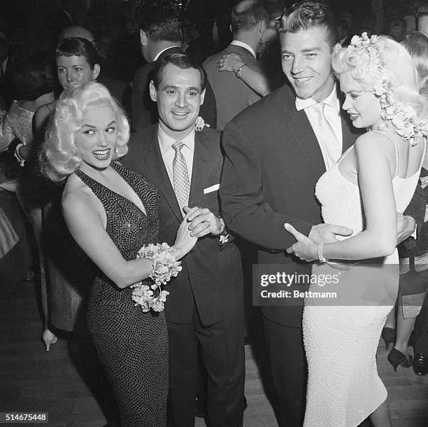 Hollywood, California: The room bubbles over as two of Hollywood's sexiest blondes meet on the dance floor at a party at the Mocambo. Left to right...