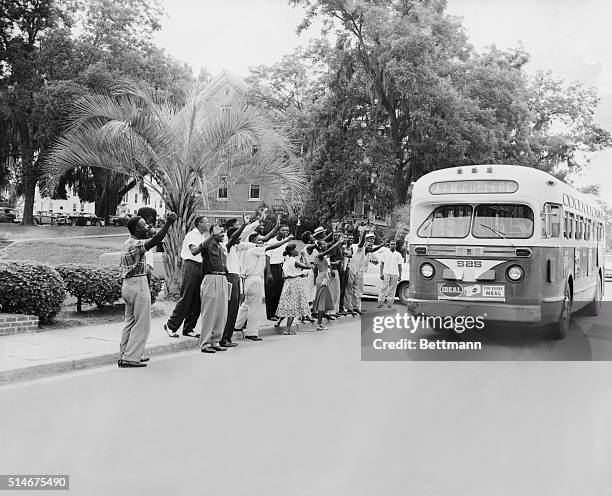 Tallahassee, FL: Negro students at Florida A&M College jeer at the driver of a city bus as he drives his empty vehicle across the school campus here,...