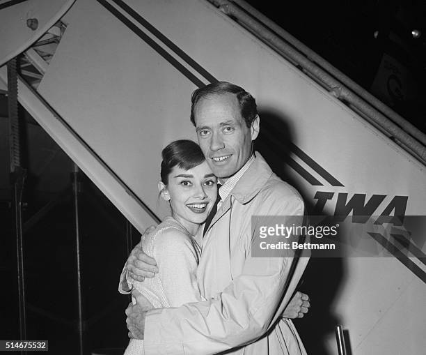 New York: Screen star Audrey Hepburn appears overjoyed to be reunited with her husband, actor Mel Ferrer, as she greets him at International Airport...