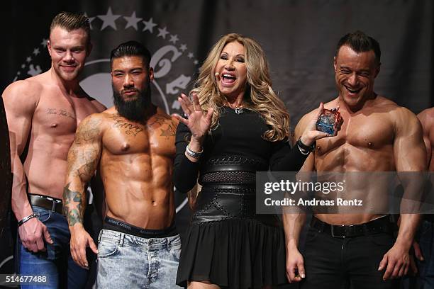 Carmen Geiss stands besides models during the public launch of a new fragrance 'Roberto Geissini' on March 10, 2016 in Cologne, Germany.