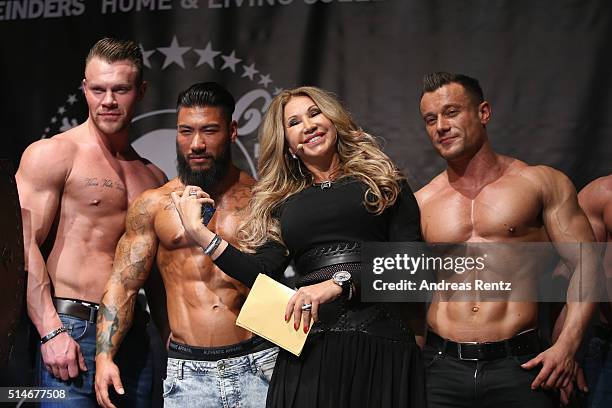 Carmen Geiss stands besides models during the public launch of a new fragrance 'Roberto Geissini' on March 10, 2016 in Cologne, Germany.