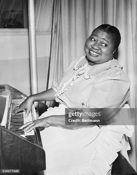 Hollywood, CA-ORIGINAL CAPTION READS: Hattie McDonald, shown playing a tune on the piano in her portrayal of the title role in "Beulah," a radio...