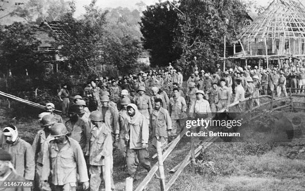 Under the guard of Communist Viet Minh troops, French and Vietnamese prisoners of war march from the battlefields of Dien Bien Phu. The 1954 battle...