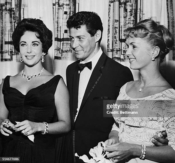 Singer Eddie Fisher is shown with his wife, Debbie Reynolds, and Elizabeth Taylor, when he opened his last engagement at the Tropicana Hotel here.