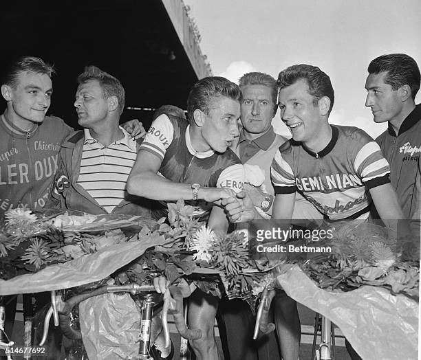 Paris, France: Jacques Anquetil, winner of the Grand Prix des Nations Cycling Race, shakes hands with runner-up Gerard Saint at the Parc des Princes...