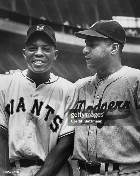 New York Giants star outfielder Willie Mays smiles as he stands with Brooklyn Dodgers catcher Roy Campanella at the Polo Grounds in New York. Ca....