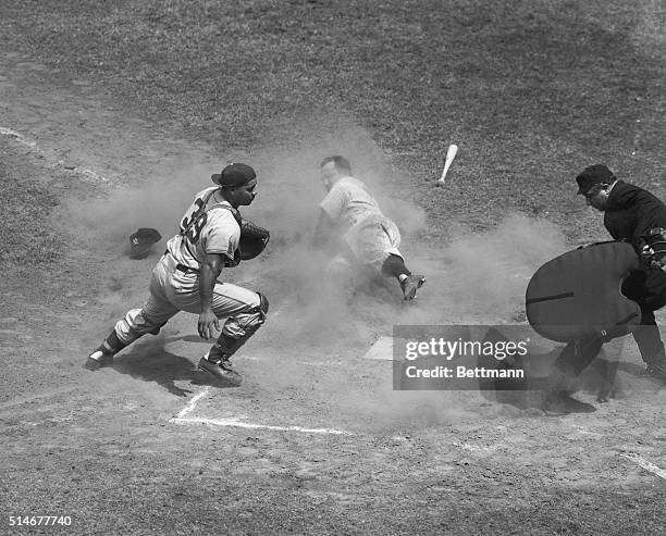 Yankees catcher Yogi Berra slides into home after Ferris Fain tripled, during the second inning of the 1951 All-Star Game. Dodgers catcher Roy...